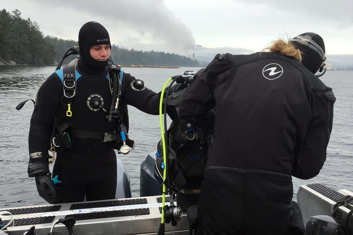 Divers, Mark Bright and Chrissy Schellenberg, prepping for their dive at the Dodd Narrows site.