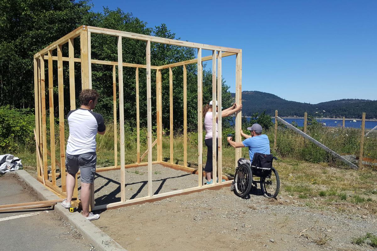 Alex, Roxanne, and Ryan begin building the smokehouse.