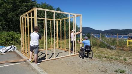 Alex, Roxanne, and Ryan begin building the smokehouse.